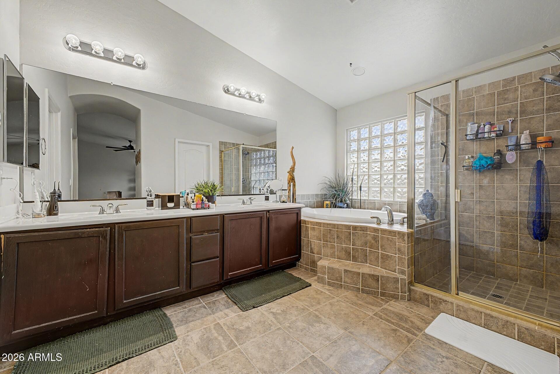 3595 East Latham Way Gilbert, AZ 85297 - Photo 16 of 35 a spacious bathroom with a shower sink and mirror