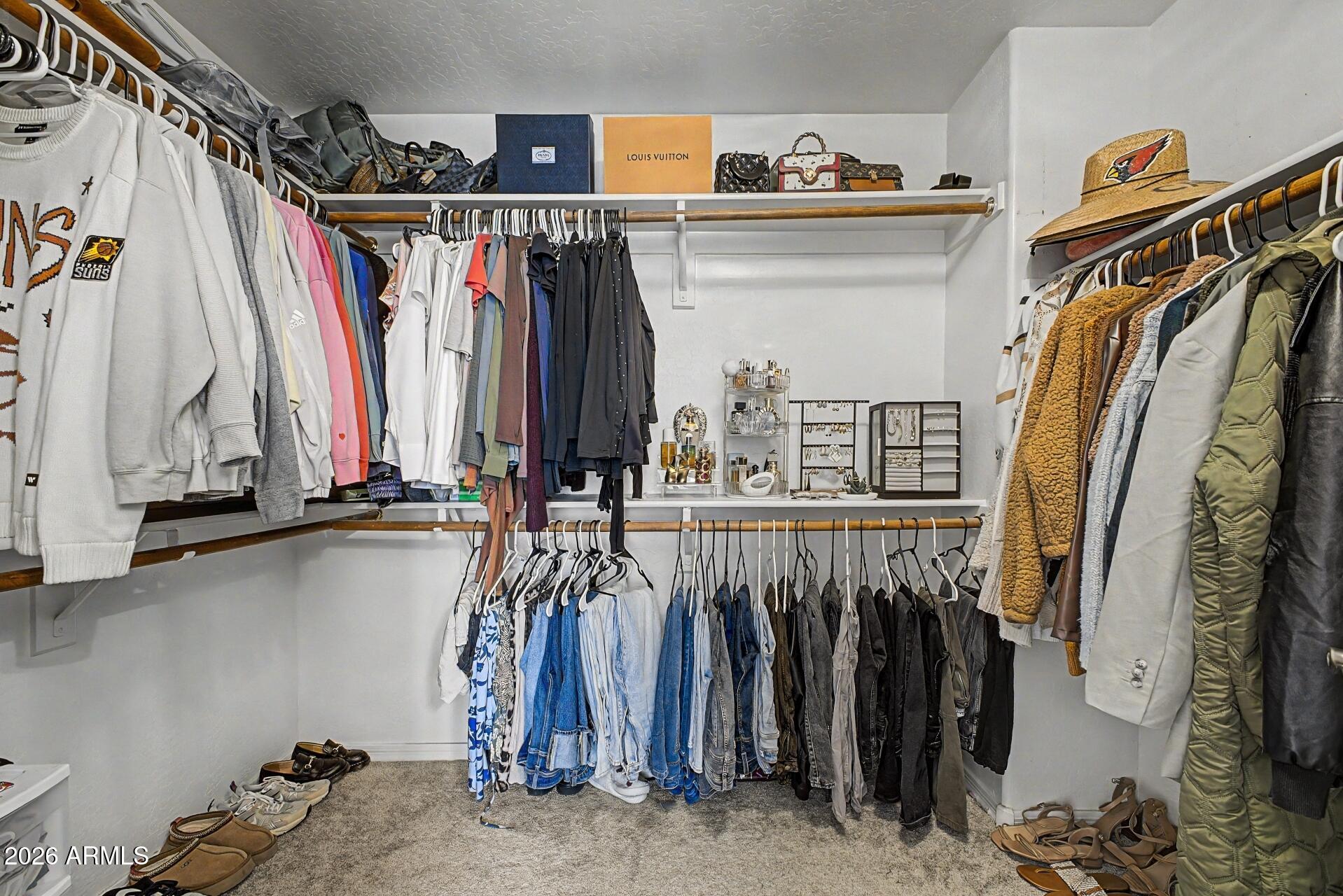 3595 East Latham Way Gilbert, AZ 85297 - Photo 18 of 35 a view of walk in closet with clothes and shoes