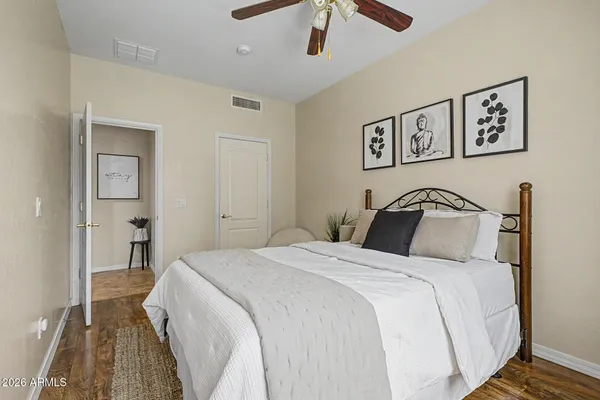 a bedroom with a large bed and a chandelier