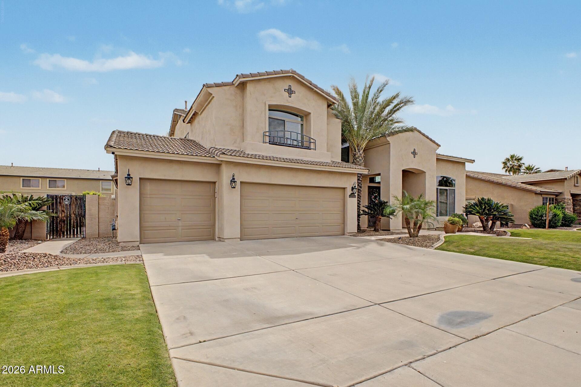3595 East Latham Way Gilbert, AZ 85297 - Photo 2 of 35 a front view of a house with a yard and garage