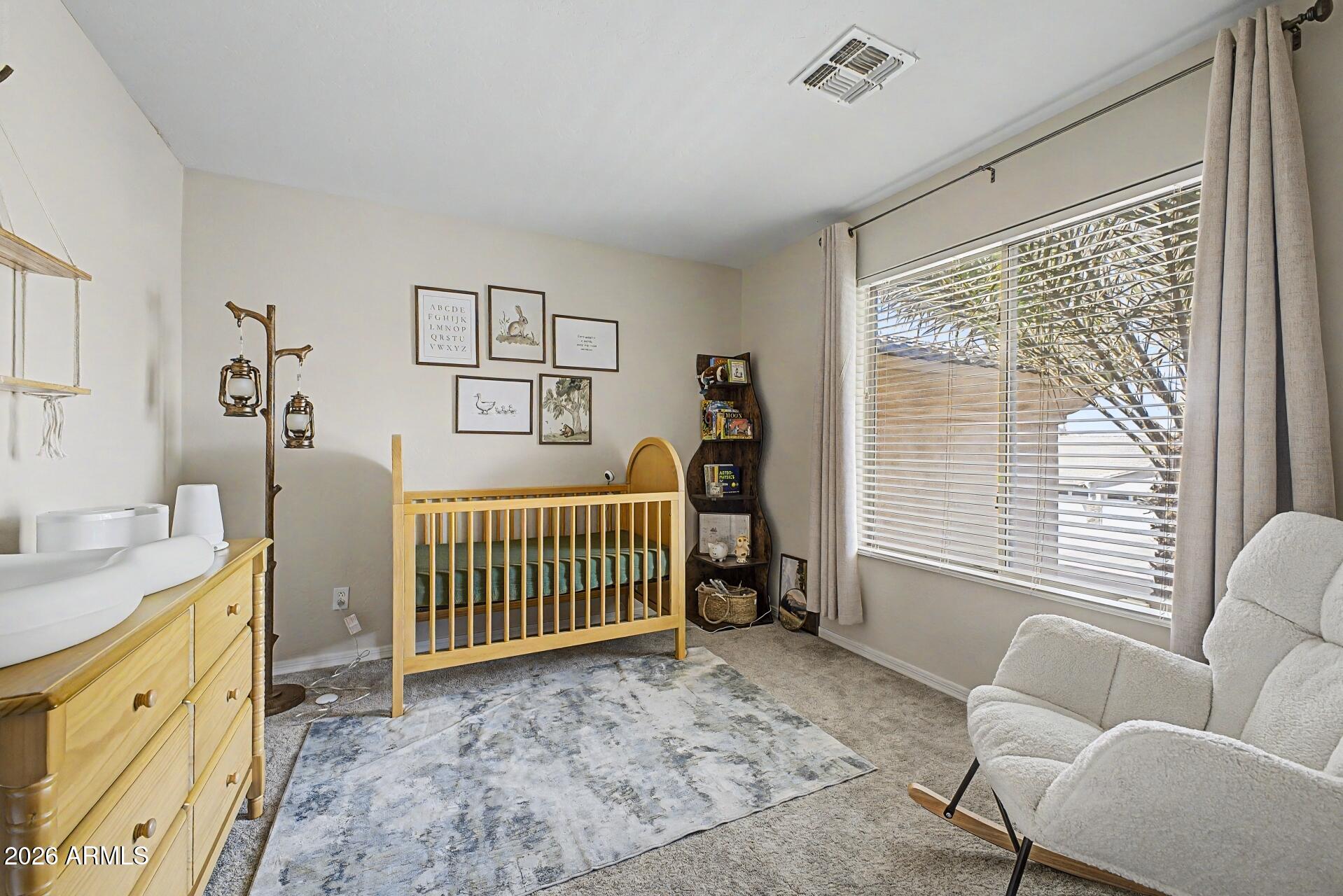 3595 East Latham Way Gilbert, AZ 85297 - Photo 26 of 35 a bedroom with furniture and a window