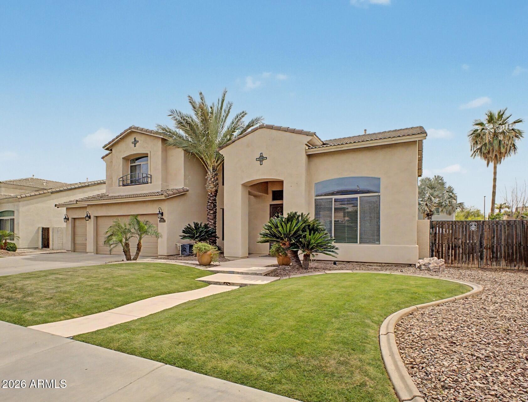 3595 East Latham Way Gilbert, AZ 85297 - Photo 3 of 35 a front view of a house with a yard