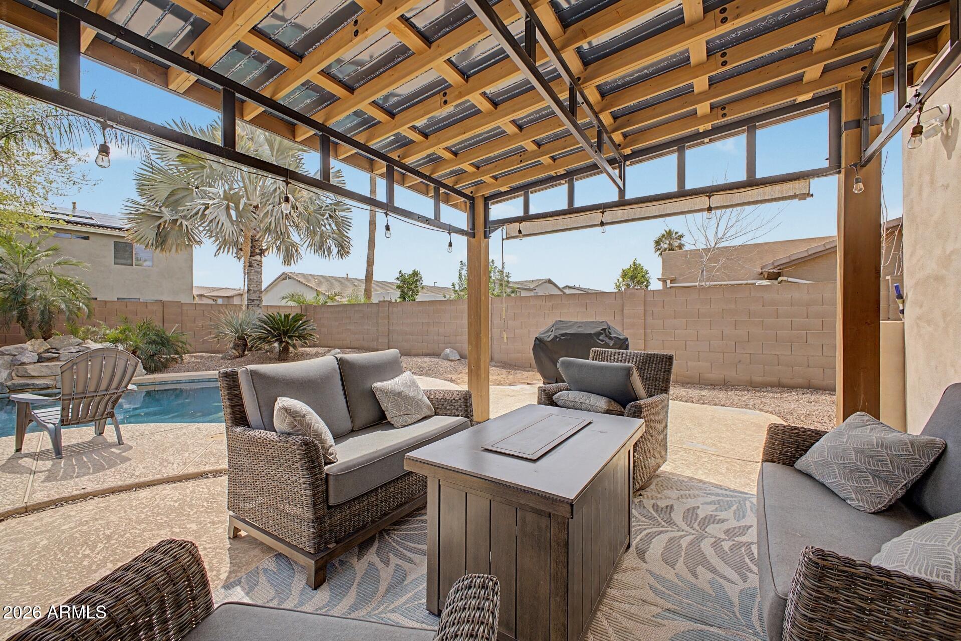 3595 East Latham Way Gilbert, AZ 85297 - Photo 31 of 35 a view of a patio with couches and table and chairs and potted plants
