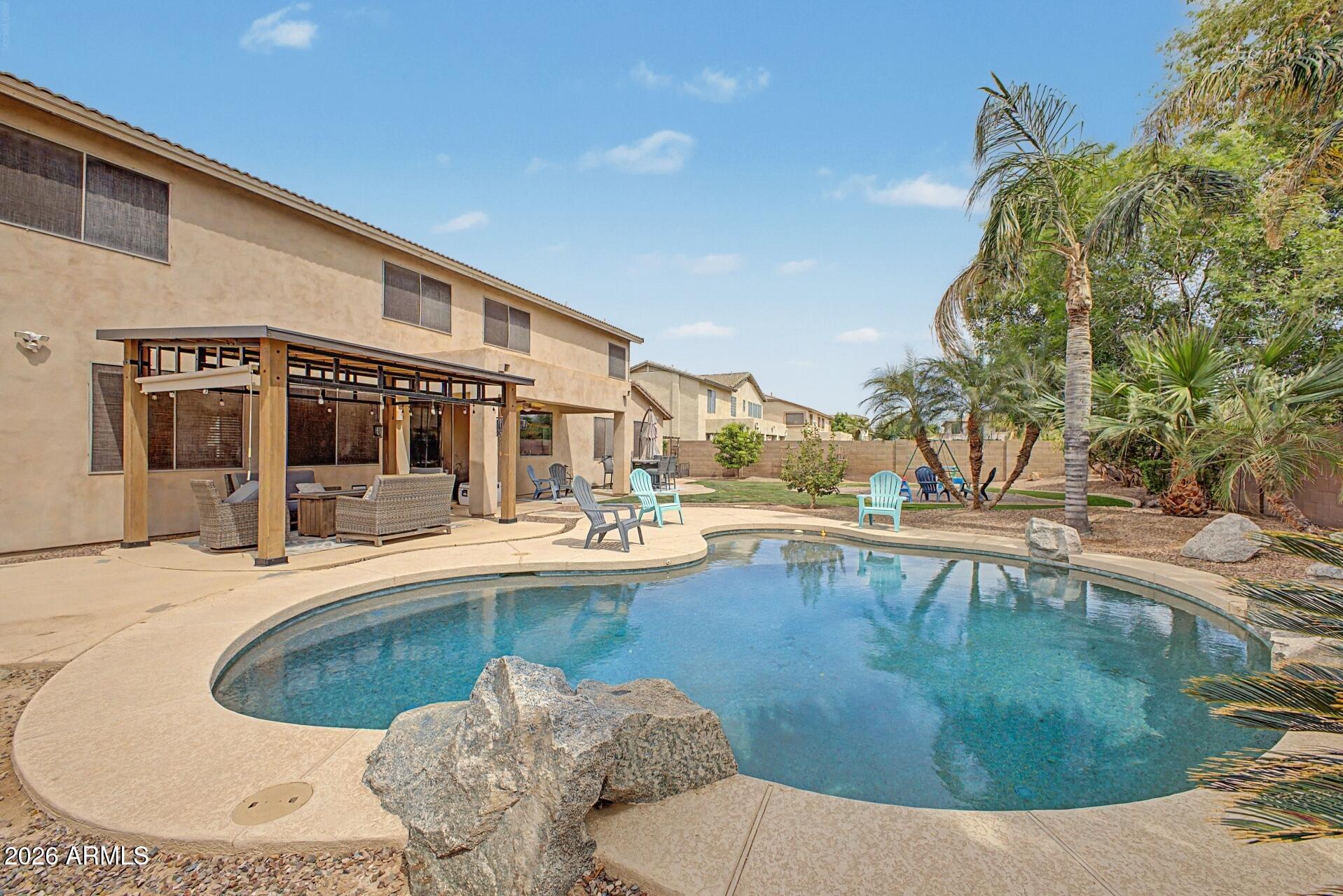 3595 East Latham Way Gilbert, AZ 85297 - Photo 32 of 35 a view of a house with swimming pool and sitting area