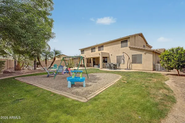 a front view of a house with fountain and garden