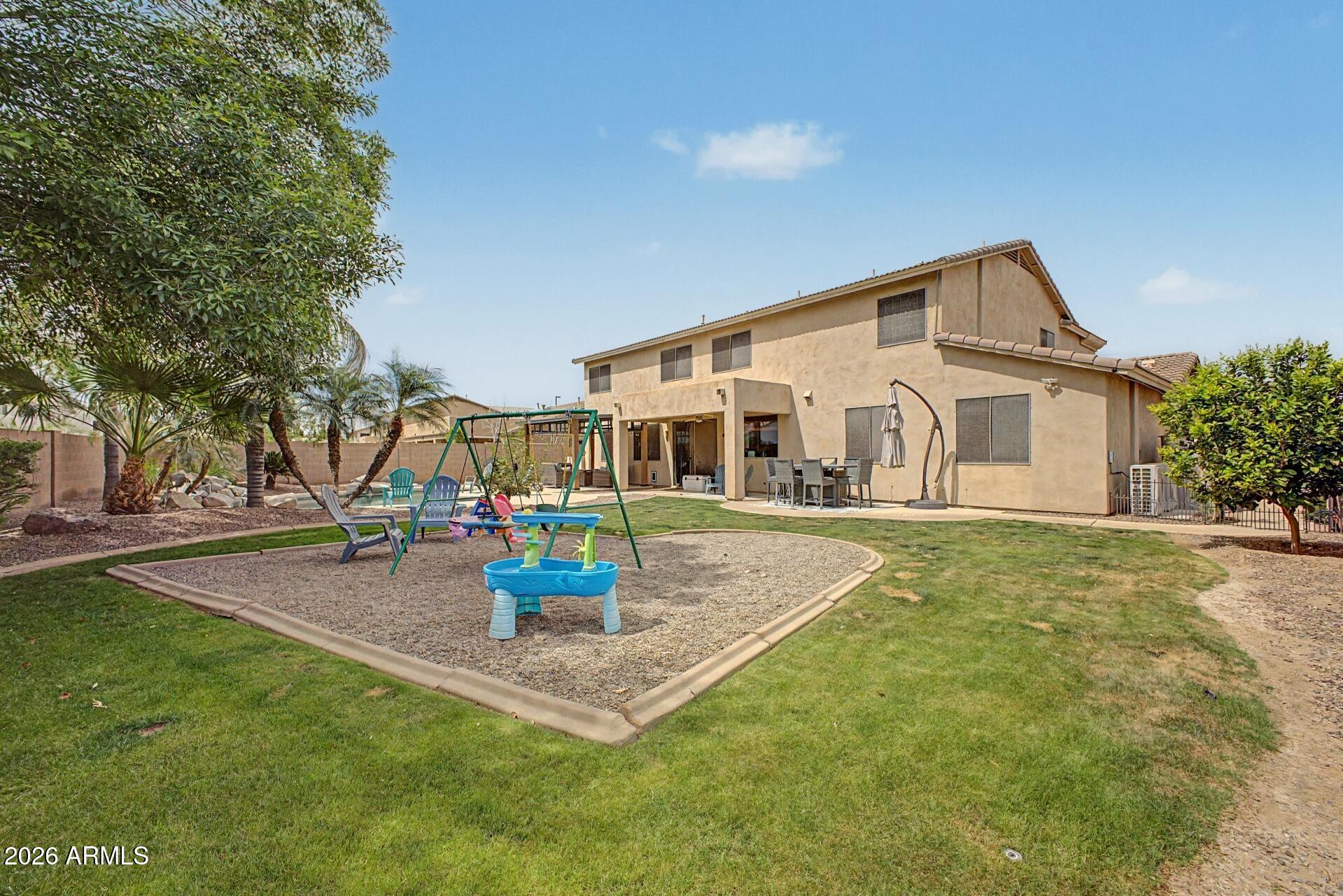 3595 East Latham Way Gilbert, AZ 85297 - Photo 34 of 35 a front view of a house with fountain and garden