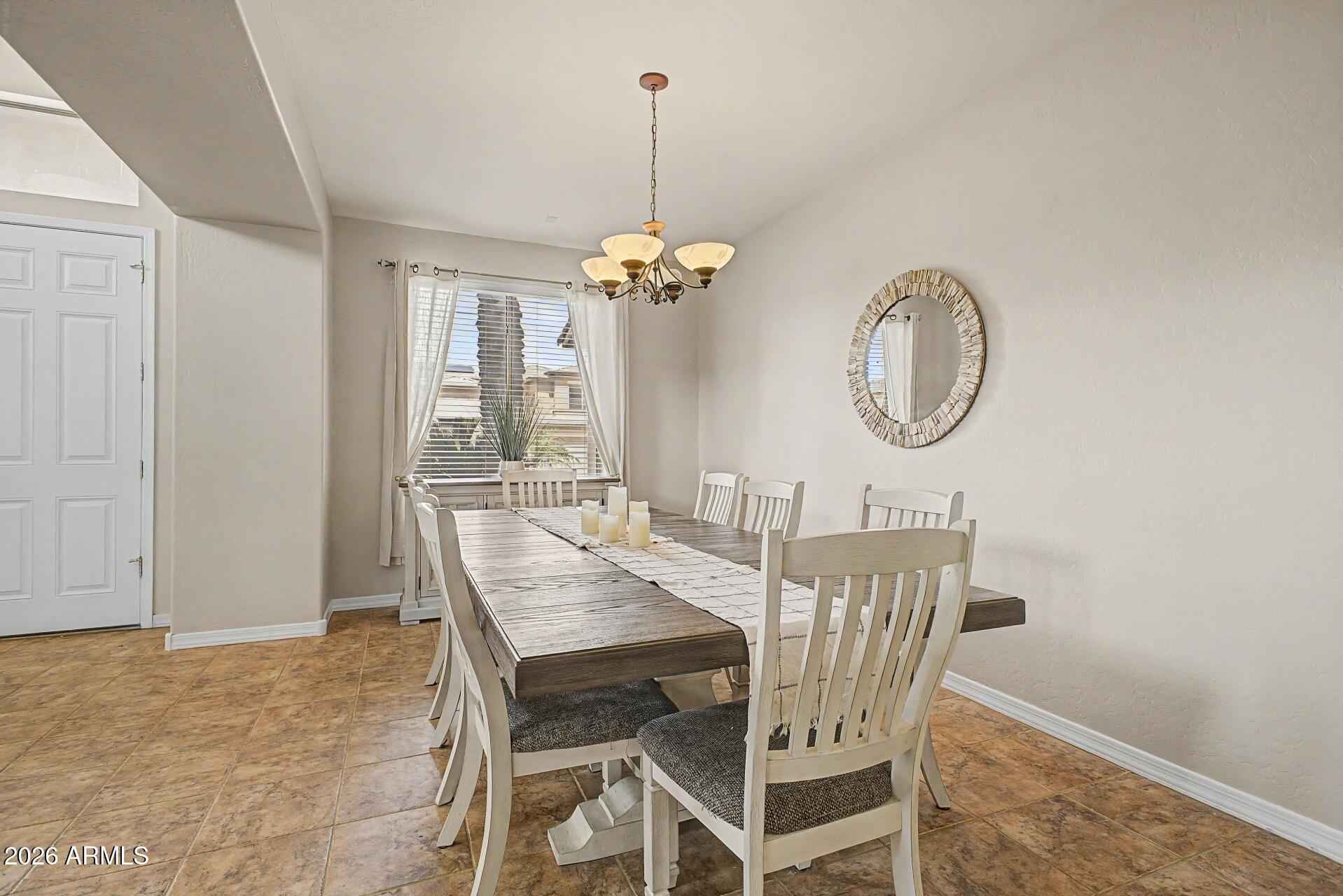 3595 East Latham Way Gilbert, AZ 85297 - Photo 4 of 35 a view of a dining room with furniture window and chandelier
