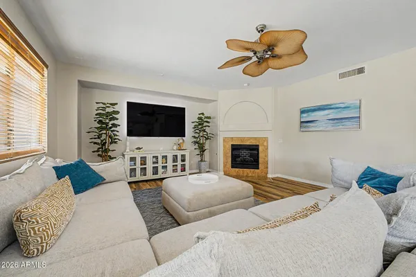 a living room with furniture a fireplace and a flat screen tv