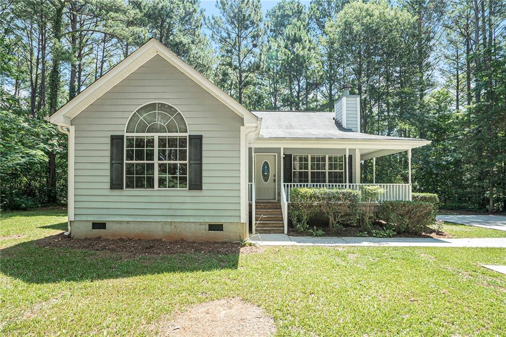 118 Rock Springs Road Milner, GA 30257 - Photo 1 of 1 a front view of a house with a yard