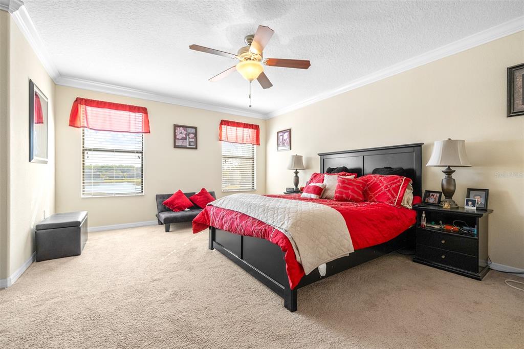 1564 Imperial Key Drive Trinity, FL 34655 - Photo 19 of 40 a bedroom with a bed and a chandelier