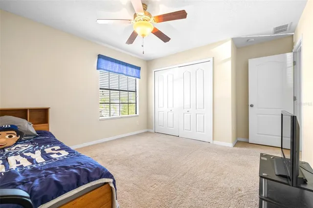 a bathroom with a granite countertop toilet sink and mirror