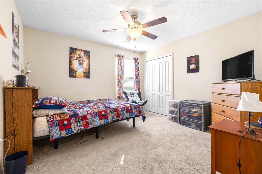 1564 Imperial Key Drive Trinity, FL 34655 - Photo 28 of 40 a bedroom with furniture and a flat screen tv