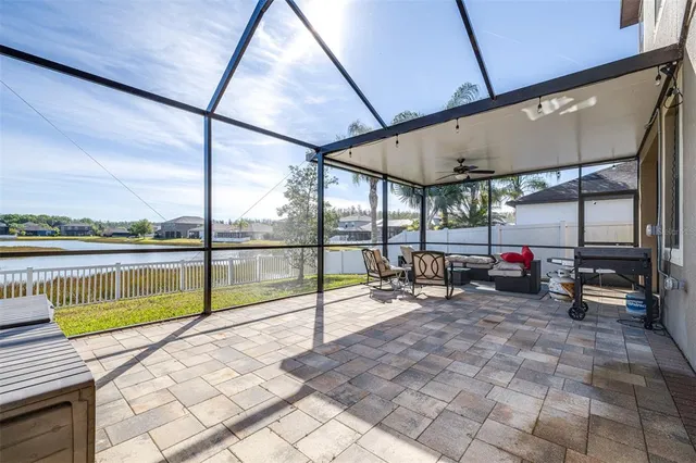 a view of a patio with table and chairs with wooden floor and fence