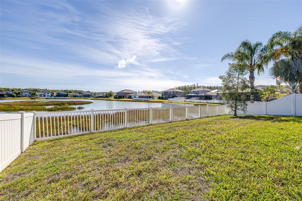 1564 Imperial Key Drive Trinity, FL 34655 - Photo 36 of 40 a view of a garden with lake in front of it
