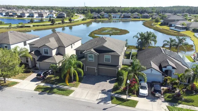 an aerial view of multiple houses with yard