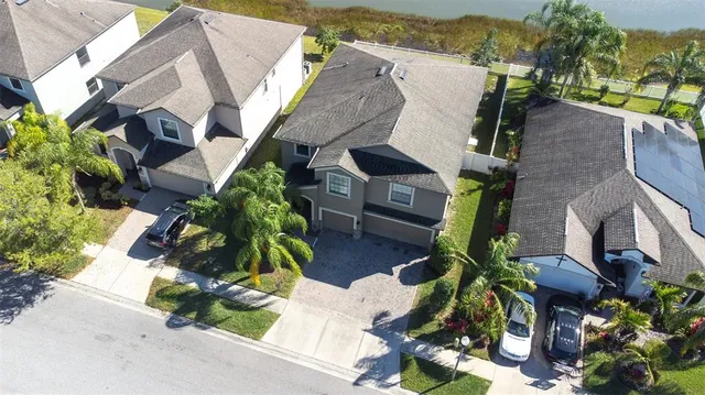 an aerial view of a house with a lake view