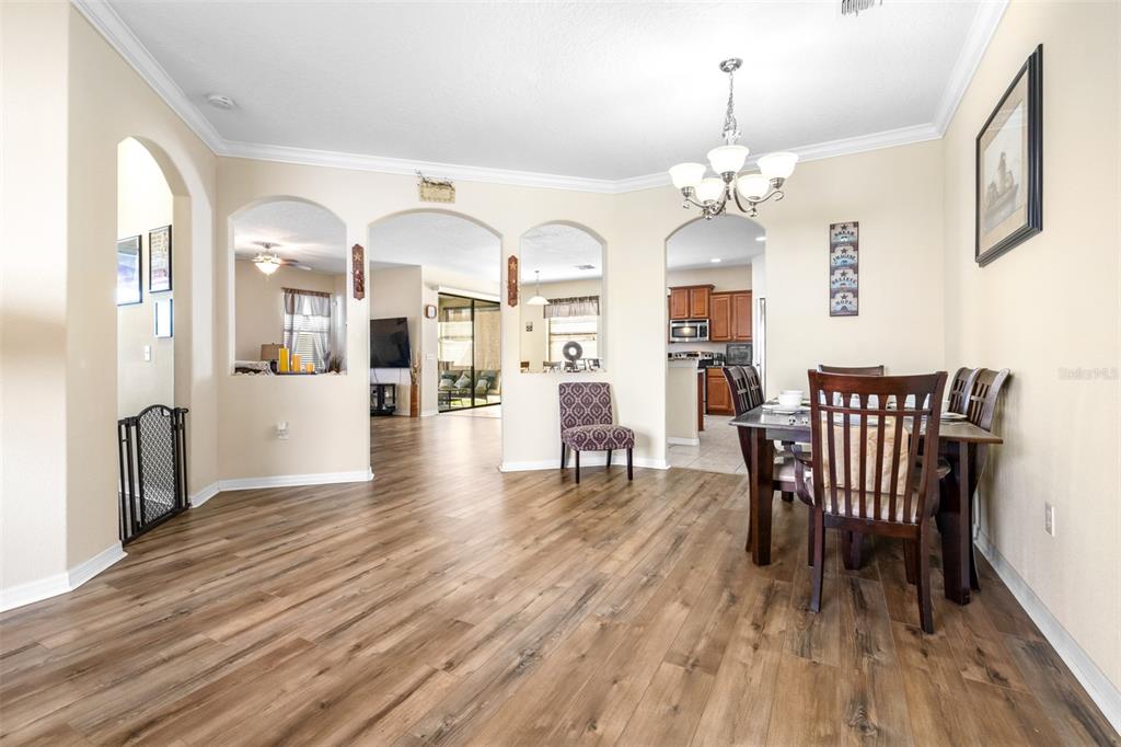 1564 Imperial Key Drive Trinity, FL 34655 - Photo 4 of 40 a view of a dining room with furniture and wooden floor