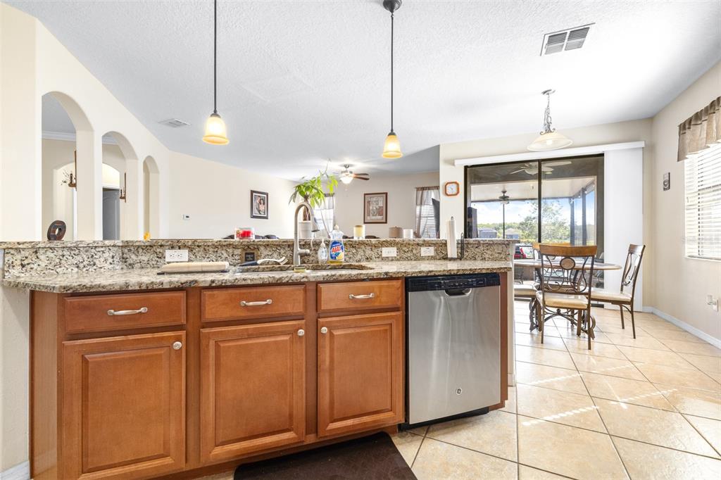 1564 Imperial Key Drive Trinity, FL 34655 - Photo 9 of 40 a kitchen with a sink a counter top space appliances and cabinets