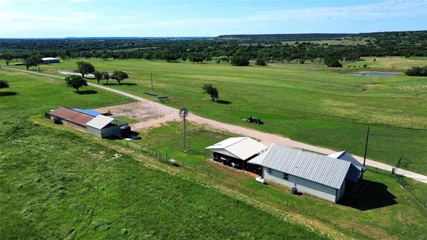 an aerial view of a house with big yard