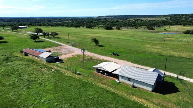 an aerial view of a house with big yard
