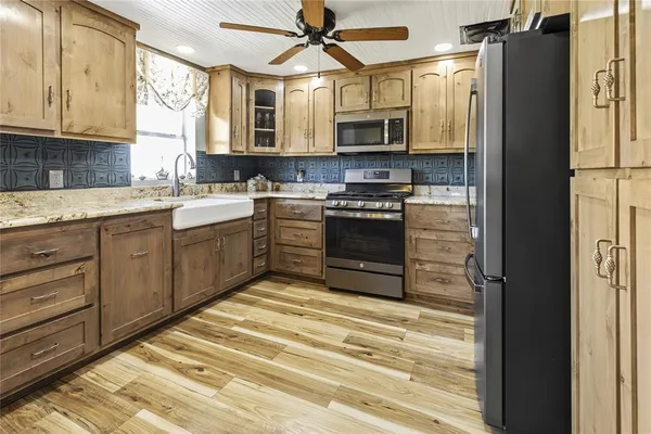 a large kitchen with a table and chairs