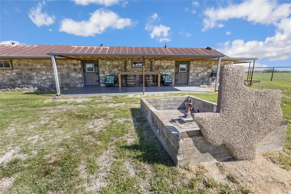a kitchen with stainless steel appliances granite countertop a sink and wooden cabinets