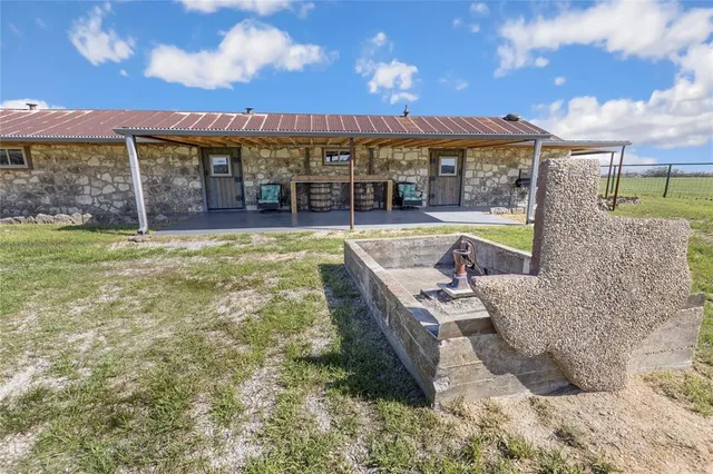 a kitchen with stainless steel appliances granite countertop a sink and wooden cabinets