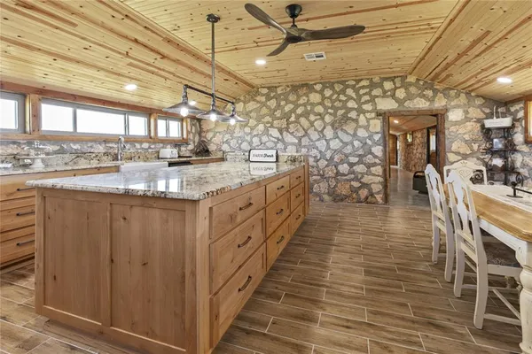 a kitchen with a sink window and white appliances