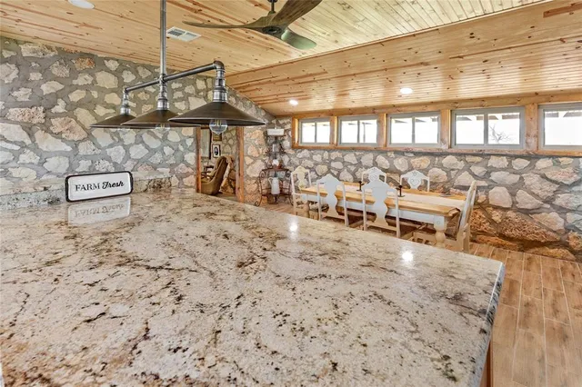 a kitchen with counter top space and wooden floor