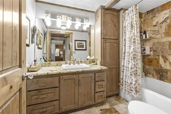 a bathroom with a toilet a sink and bathtub
