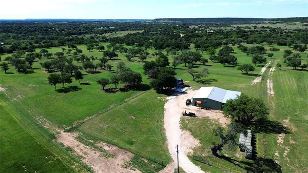 an aerial view of a house with yard