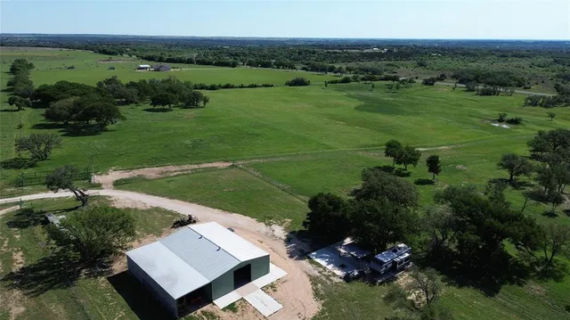 an aerial view of a house with yard