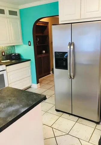 a kitchen with stainless steel appliances granite countertop a refrigerator and a sink