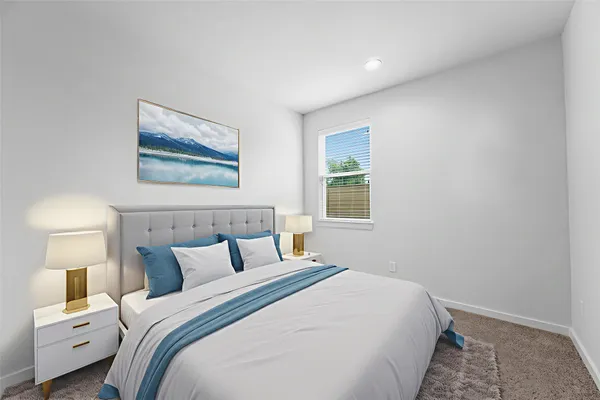 a bedroom with a bed and a night stand