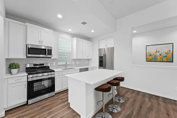 a kitchen with a stove a sink and a microwave