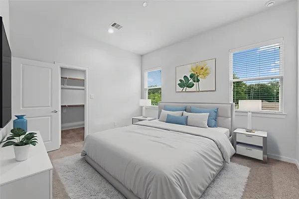 a bedroom with a bed and a couch