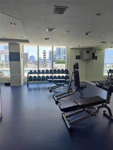 a room with gym equipment and a large window
