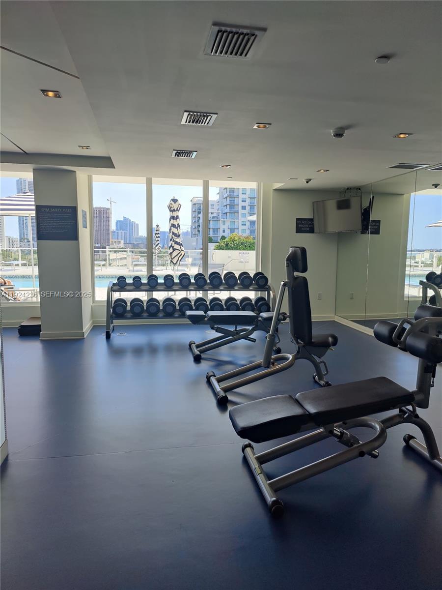 4250 Biscayne Boulevard, Unit 514 Miami, FL 33137 - Photo 8 of 16 a room with gym equipment and a large window
