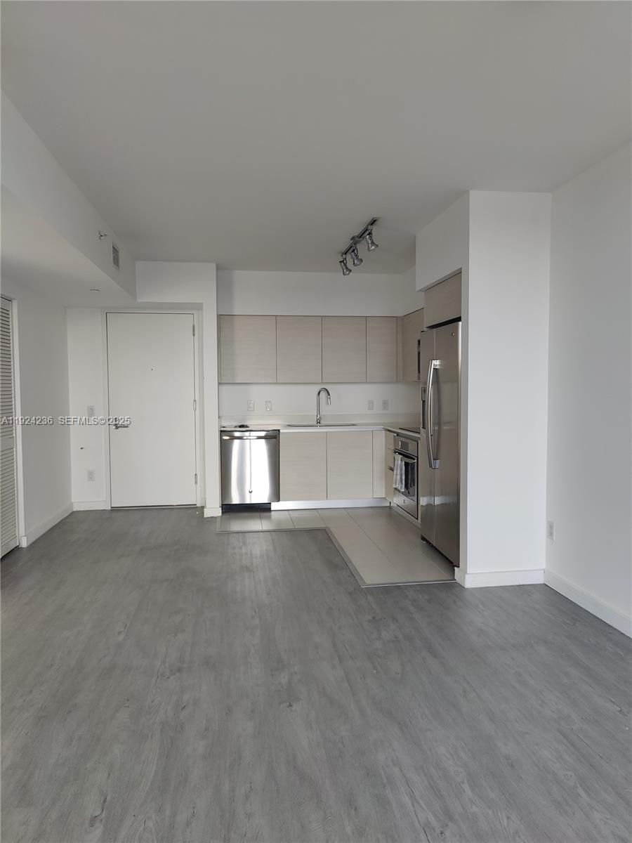 4250 Biscayne Boulevard, Unit 514 Miami, FL 33137 - Photo 10 of 16 a view of a kitchen with a sink and refrigerator in it
