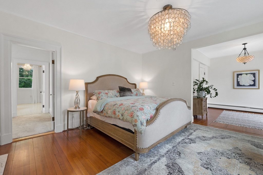 20 Eulow Street Swampscott, MA 01907 - Photo 14 of 42 a bedroom with a bed and a chandelier
