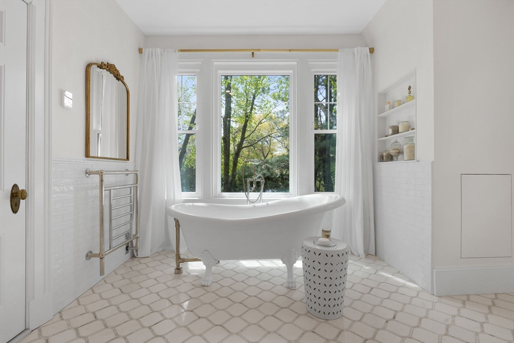20 Eulow Street Swampscott, MA 01907 - Photo 18 of 42 a white bath tub sitting in a bathroom next to a window