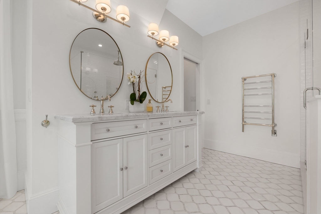 20 Eulow Street Swampscott, MA 01907 - Photo 20 of 42 a bathroom with a mirror sink and cabinets