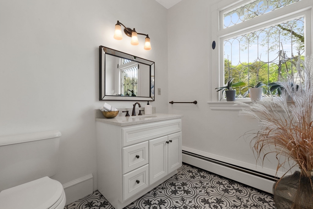 20 Eulow Street Swampscott, MA 01907 - Photo 30 of 42 a bathroom with a granite countertop sink mirror vanity and toilet