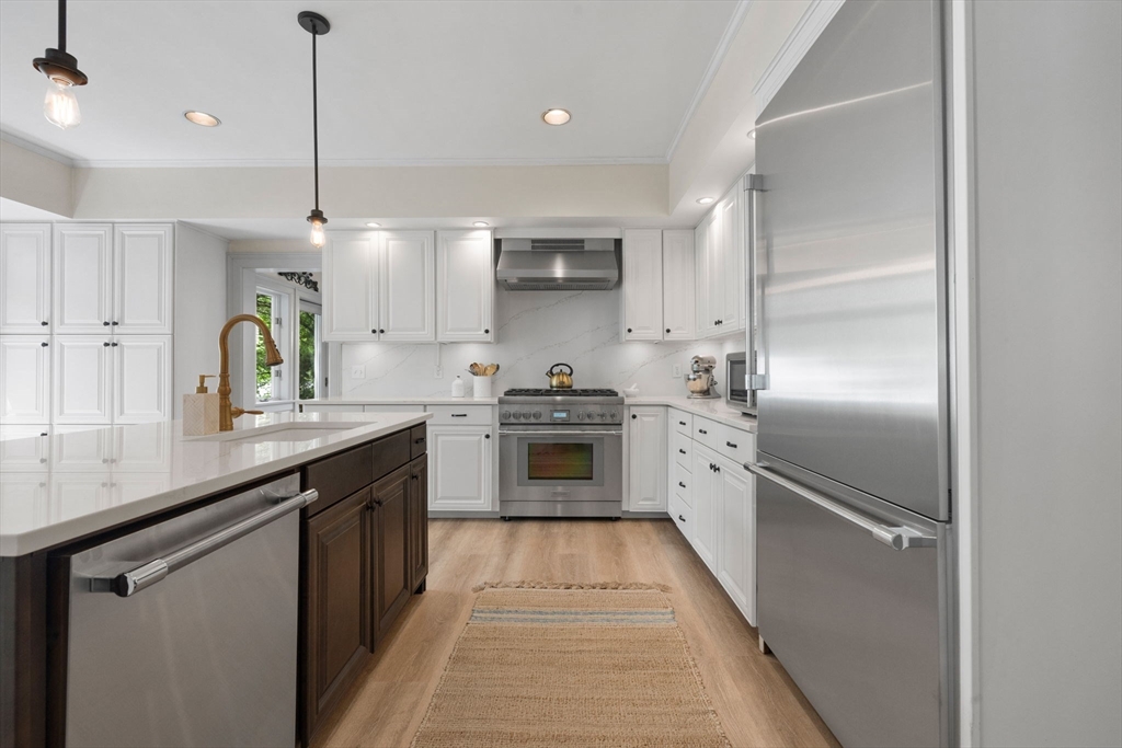 20 Eulow Street Swampscott, MA 01907 - Photo 6 of 42 a kitchen with stainless steel appliances granite countertop a sink a stove and a refrigerator