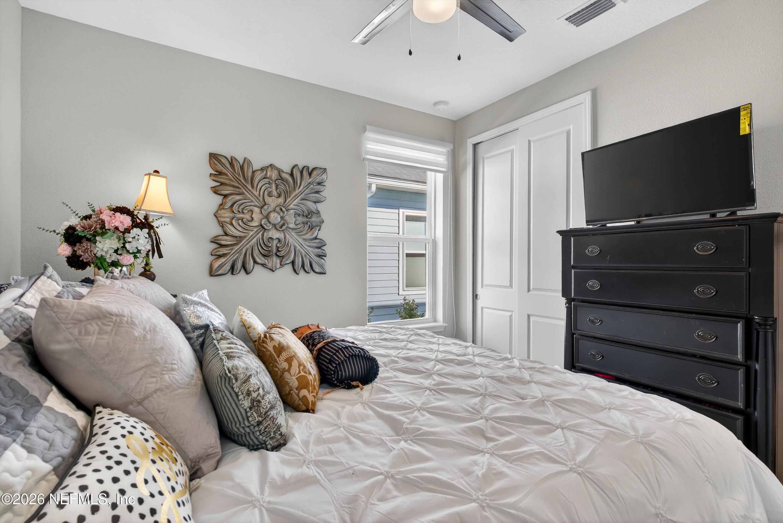 1055 Rustic Mill Dr Street St. Augustine, FL 32092 - Photo 25 of 87 a bedroom with a bed and a flat screen tv