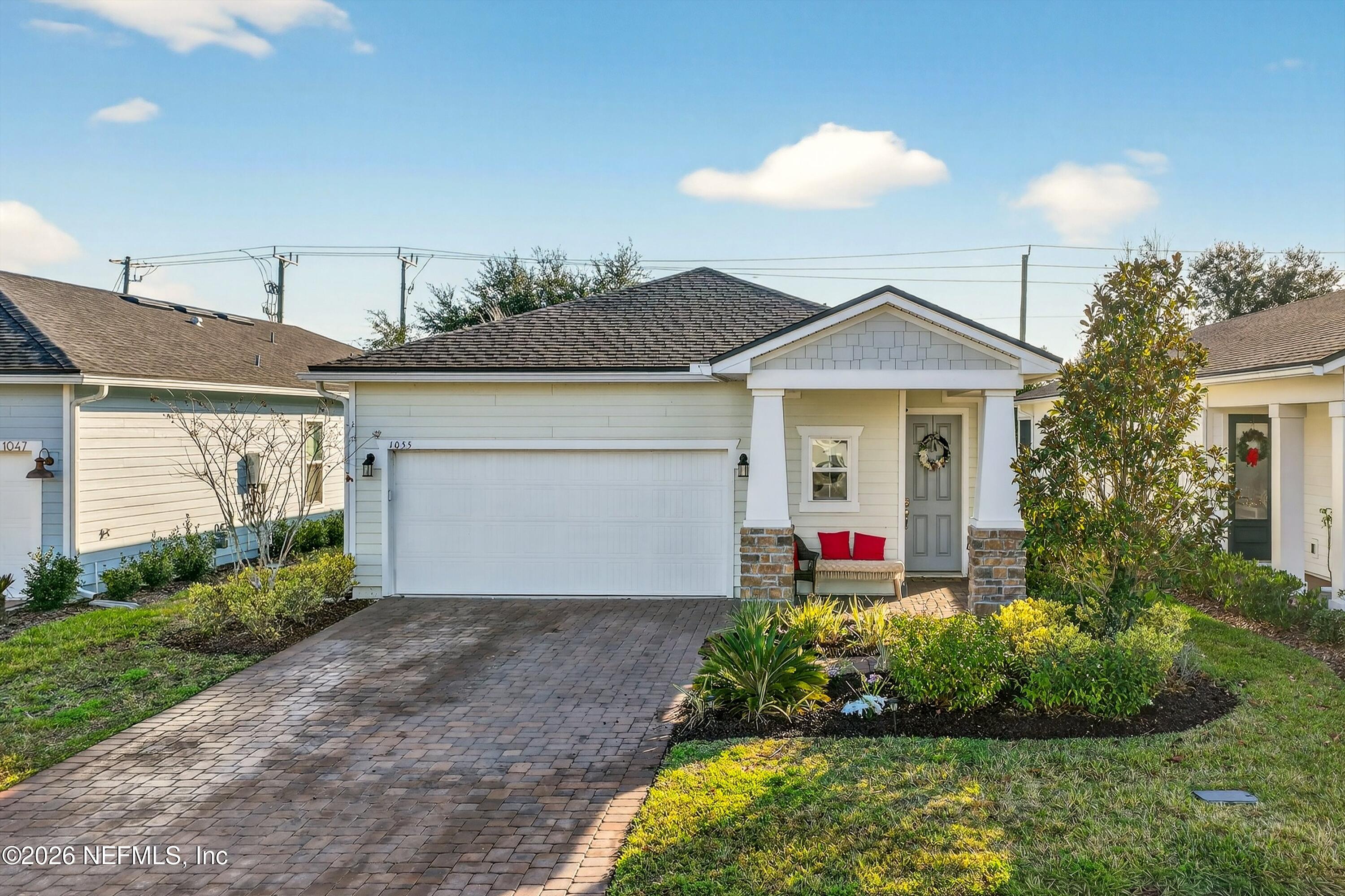 1055 Rustic Mill Dr Street St. Augustine, FL 32092 - Photo 86 of 87 a front view of a house with a yard and potted plants