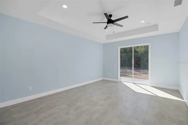 a view of a livingroom with a ceiling fan and window