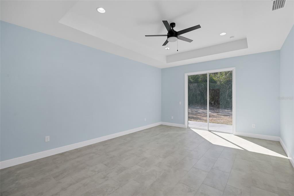 7604 Southwest 103rd Loop Ocala, FL 34476 - Photo 11 of 20 a view of a livingroom with a ceiling fan and window