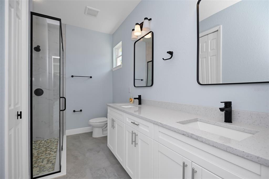 7604 Southwest 103rd Loop Ocala, FL 34476 - Photo 12 of 20 a bathroom with a toilet sink and mirror