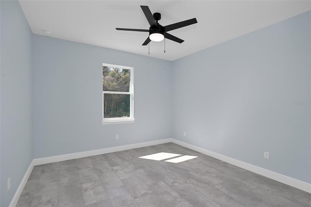 7604 Southwest 103rd Loop Ocala, FL 34476 - Photo 15 of 20 an empty room with a window and a fan